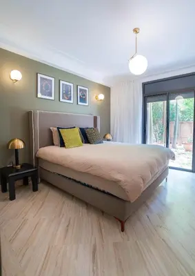 a bedroom with a large bed in a room at Un magnifique appartement avec jardin à Marrakech in Marrakech