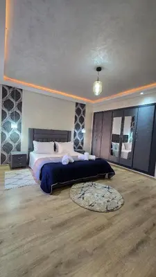 a large bedroom with a large bed and a rug at Luxury Penthouse and Jacuzzi at Hivernage in Marrakech