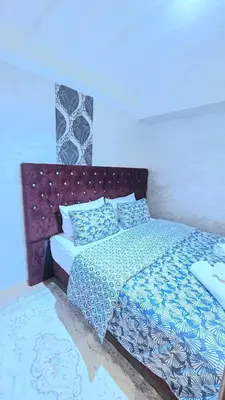 a bedroom with a bed with blue and white sheets at Luxury Penthouse and Jacuzzi at Hivernage in Marrakech