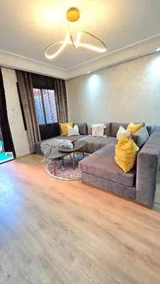 a living room with a couch and a table at Luxury Penthouse and Jacuzzi at Hivernage in Marrakech