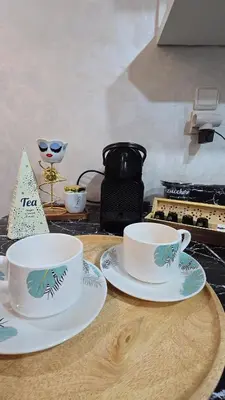 a table with two tea cups and plates on it at Luxury Penthouse and Jacuzzi at Hivernage in Marrakech
