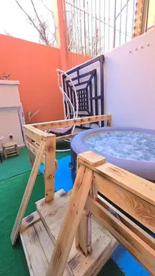 a patio with a hot tub and a table and chairs at Luxury Penthouse and Jacuzzi at Hivernage in Marrakech