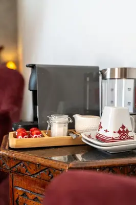 a table with a coffee maker and a cake on it at Riad Serendip in Marrakech