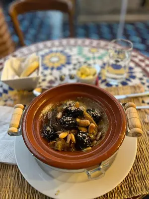 a bowl of soup on a plate on a table at Riad Serendip in Marrakech