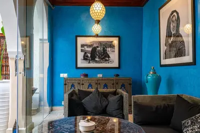 a blue living room with a couch and a table at Riad Serendip in Marrakech