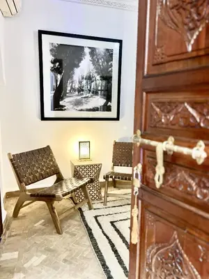 a room with two chairs and a door at Riad Serendip in Marrakech