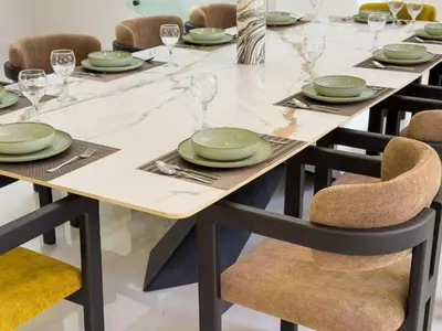 a table with chairs and plates and wine glasses at VILLA DE LUXE à Marrakech, GOLF, Piscine, 10 min du centre in Marrakech