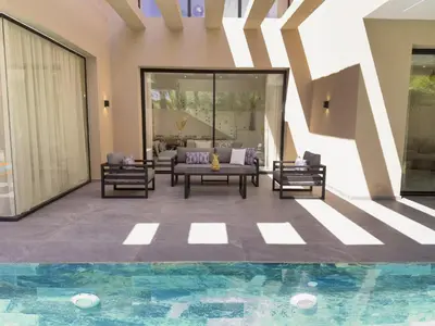 a living room with a couch and chairs and a pool at VILLA DE LUXE à Marrakech, GOLF, Piscine, 10 min du centre in Marrakech