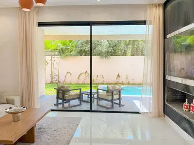 a living room with a view of a pool at VILLA DE LUXE à Marrakech, GOLF, Piscine, 10 min du centre in Marrakech