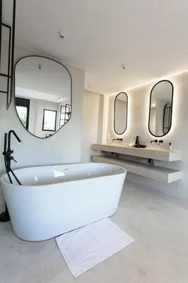 a white bathroom with a tub and two mirrors at The view City Center in Marrakech