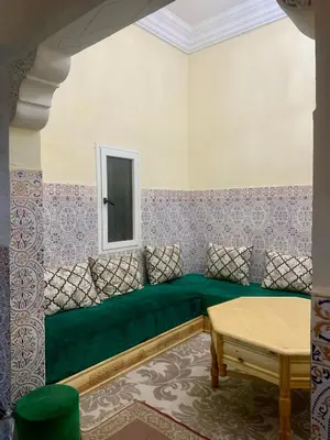 a green couch in a room with a window at Maison Marrakech in Marrakech