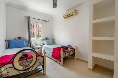 a bedroom with two beds and a window at New Stylish Riad - 4BR with Pool Access in Marrakech