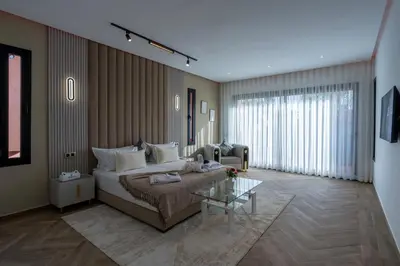 a bedroom with a bed and a table in a room at Villa Mareva & Spa Marrakech in Marrakech