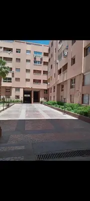 a large building with a courtyard in front of it at Appart 2 CH lumineux et une piscine pour votre séjour in Marrakech