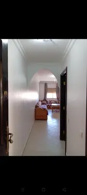 a room with a bedroom with a bed and a hallway at Appart 2 CH lumineux et une piscine pour votre séjour in Marrakech