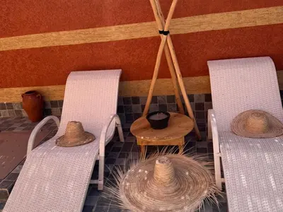 three chairs and a table with hats on them at Villa cosy & pool Marrakech in Marrakech