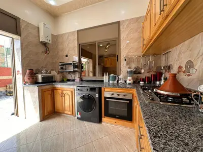 a kitchen with a stove and a dishwasher at Villa cosy & pool Marrakech in Marrakech