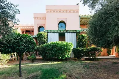 a building with a tree in front of it at Palmeraie - Open Garden & Pool in Marrakech