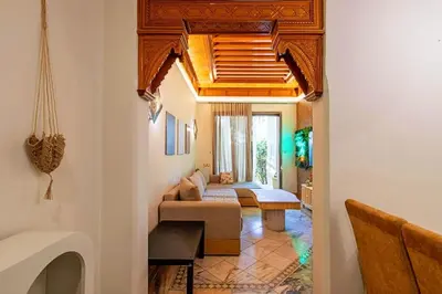 a living room with a couch and a bed at Palmeraie - Open Garden & Pool in Marrakech