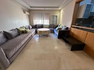 a living room with a couch and a table at Appartement chaleureux au cœur de Marrakech in Marrakech