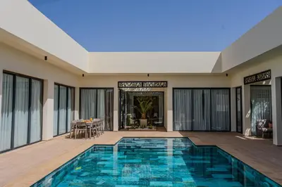 a swimming pool in the middle of a house at Les Villas D'Amelkis in Marrakech