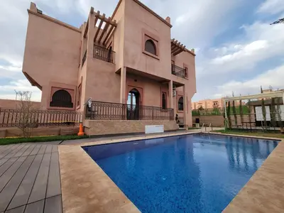 a house with a swimming pool in front of it at Villa Marrakech Rimass - 6 Chambres Dont 5 Suites Luxe, Piscine Privee & Jardins in Marrakech
