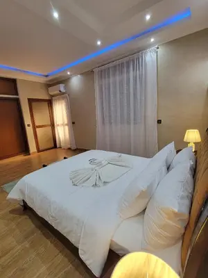 a bedroom with a large bed with white sheets and pillows at Villa Marrakech Rimass - 6 Chambres Dont 5 Suites Luxe, Piscine Privee & Jardins in Marrakech