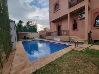 a swimming pool in front of a house at Villa Marrakech Rimass - 6 Chambres Dont 5 Suites Luxe, Piscine Privee & Jardins in Marrakech