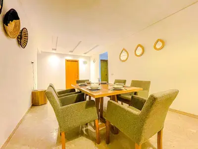 a dining room with a wooden table and chairs at Luxury Aprt 2-bedrooms-Pool Hivernage City Centre-Free Parking in Marrakech