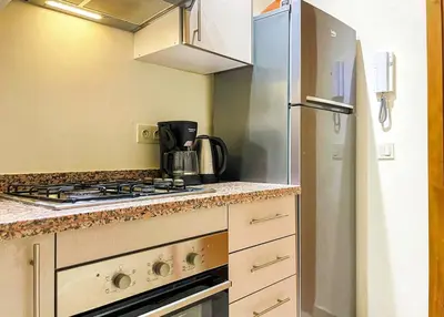 a kitchen with a stove and a refrigerator at Luxury Aprt 2-bedrooms-Pool Hivernage City Centre-Free Parking in Marrakech