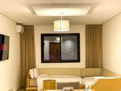 a living room with a couch and a mirror at Luxury Aprt 2-bedrooms-Pool Hivernage City Centre-Free Parking in Marrakech