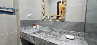 a bathroom with a marble sink and a mirror at Appartement 2 chambres à Guéliz avec terrasse et parking in Marrakech