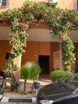 an entrance to a building with an arch with plants at Youssef House Le Village Touristique in Marrakech