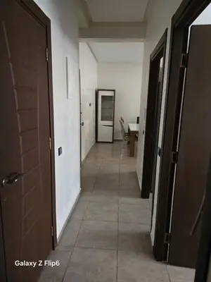 a corridor of a hallway with a door and a table at APPARTEMENT à TARGA in Marrakech