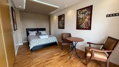 a bedroom with a bed and a table and chairs at Private Villa with Pool in Marrakech