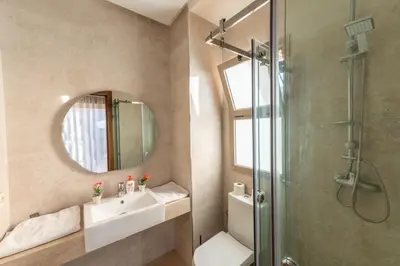 a bathroom with a shower and a sink and a mirror at Villa 3 in Marrakech