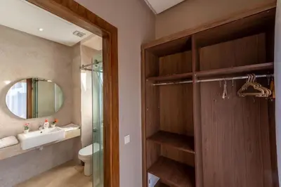 a bathroom with a sink and a toilet and a mirror at Villa 3 in Marrakech