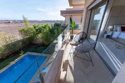 a balcony with a swimming pool on a house at Villa 3 in Marrakech