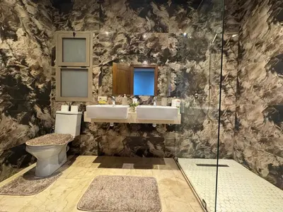 a bathroom with a toilet and a sink and a shower at Villa 5 in Marrakech