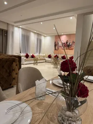 a dining room table with a vase of flowers on it at Villa 5 in Marrakech