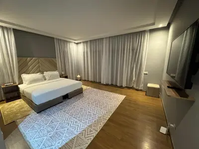 a bedroom with a bed and a flat screen tv at Villa 5 in Marrakech