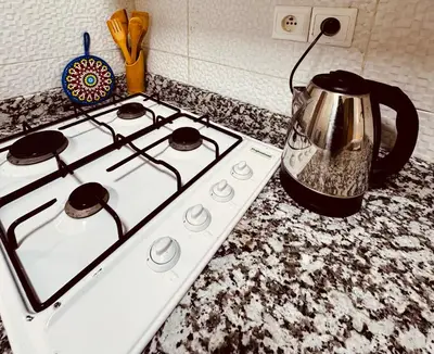 a white stove top with a tea kettle on it at Jardin de chrifia cosy in Marrakech