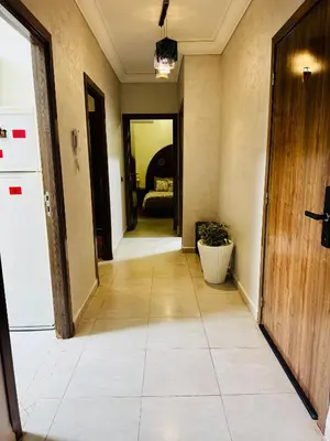 an empty hallway with a door and a plant at Jardin de chrifia cosy in Marrakech