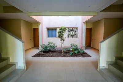 a hallway of a building with a plant at Luxury golf Prestigia Saphir in Marrakech
