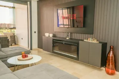 a living room with a couch and a fireplace at Luxury golf Prestigia Saphir in Marrakech