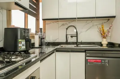 a kitchen with a sink and a coffee maker at Luxury golf Prestigia Saphir in Marrakech