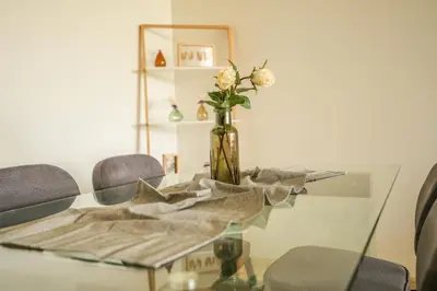 a glass table with a vase with flowers on it at Luxury golf Prestigia Saphir in Marrakech
