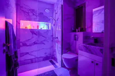 a purple bathroom with a shower and a toilet at Luxury golf Prestigia Saphir in Marrakech