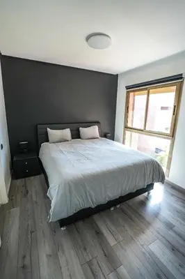 a bedroom with a large bed and a large window at Luxury golf Prestigia Saphir in Marrakech