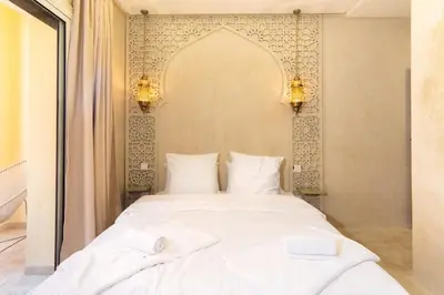 a bedroom with a white bed with two white pillows at Suite Jasmin Elegance a Gueliz in Marrakech